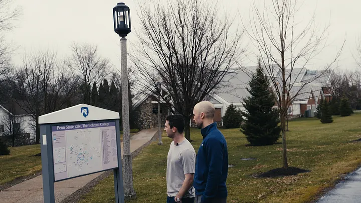 Two attendees talking outside on the college campus