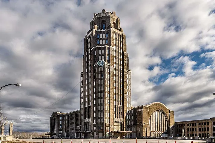 Buffalo Central Terminal seen from the street, its seventeen-storey Art Deco tower against a cloudy sky